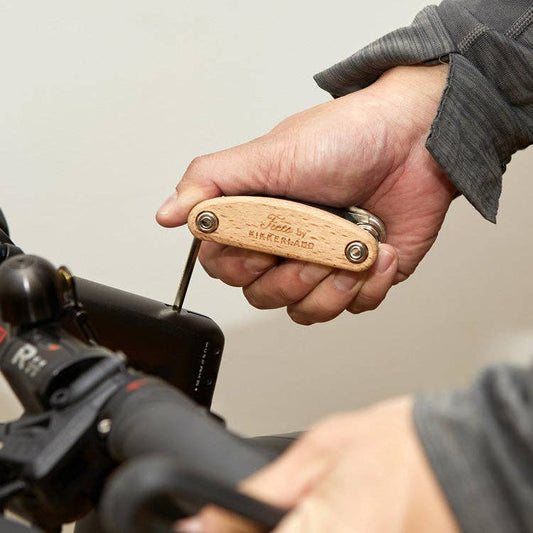 Person using the 16-in-1 Wooden Multi-Tool