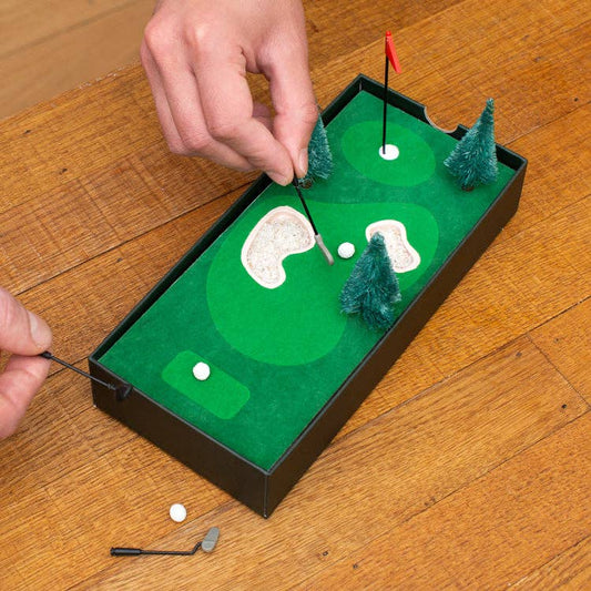 A couple of people playing the Desktop Mini Golf Set with their hands