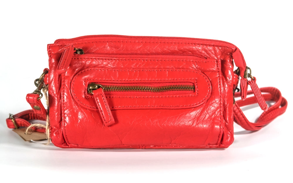 Red vegan leather convertible handbag with zippers on a white background.