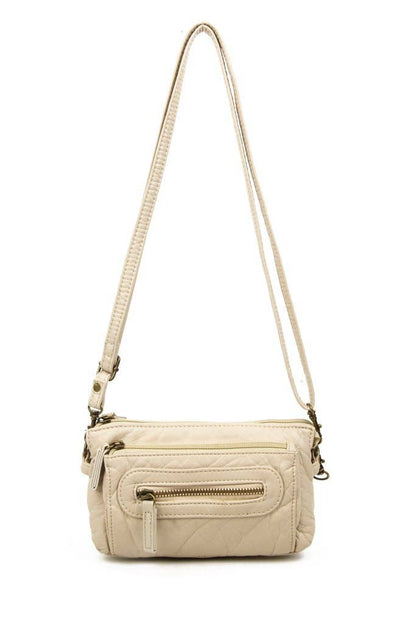 Almond crossbody bag with a strap on a white background