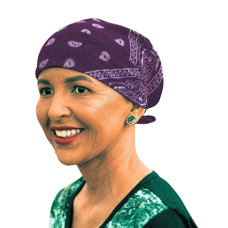 A stylized portrait illustration of a smiling woman in profile wearing a red patterned bandana headwrap, rendered with black line art on a white background.