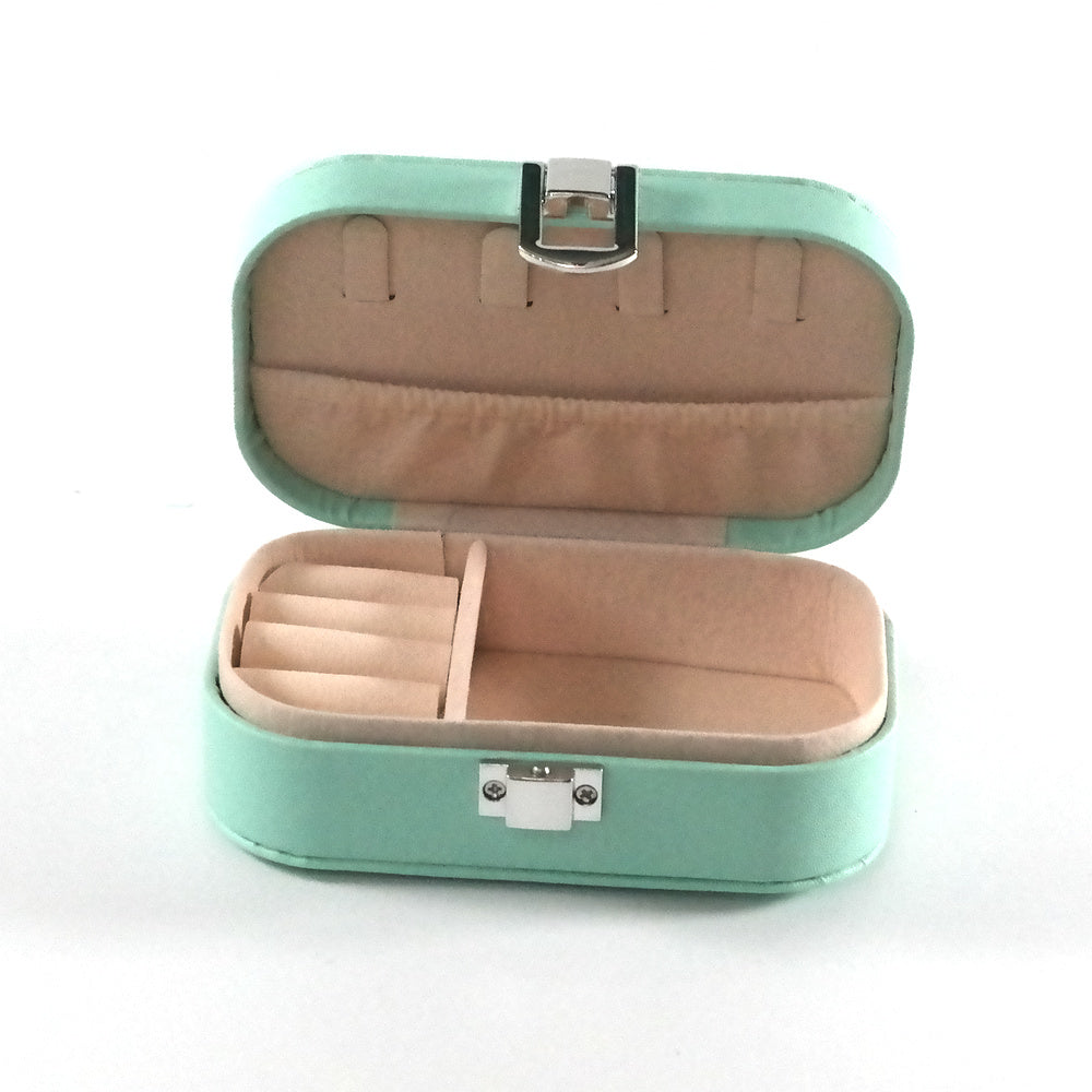 Miniature teal jewelry box open with compartments and a cream colored fabric.  