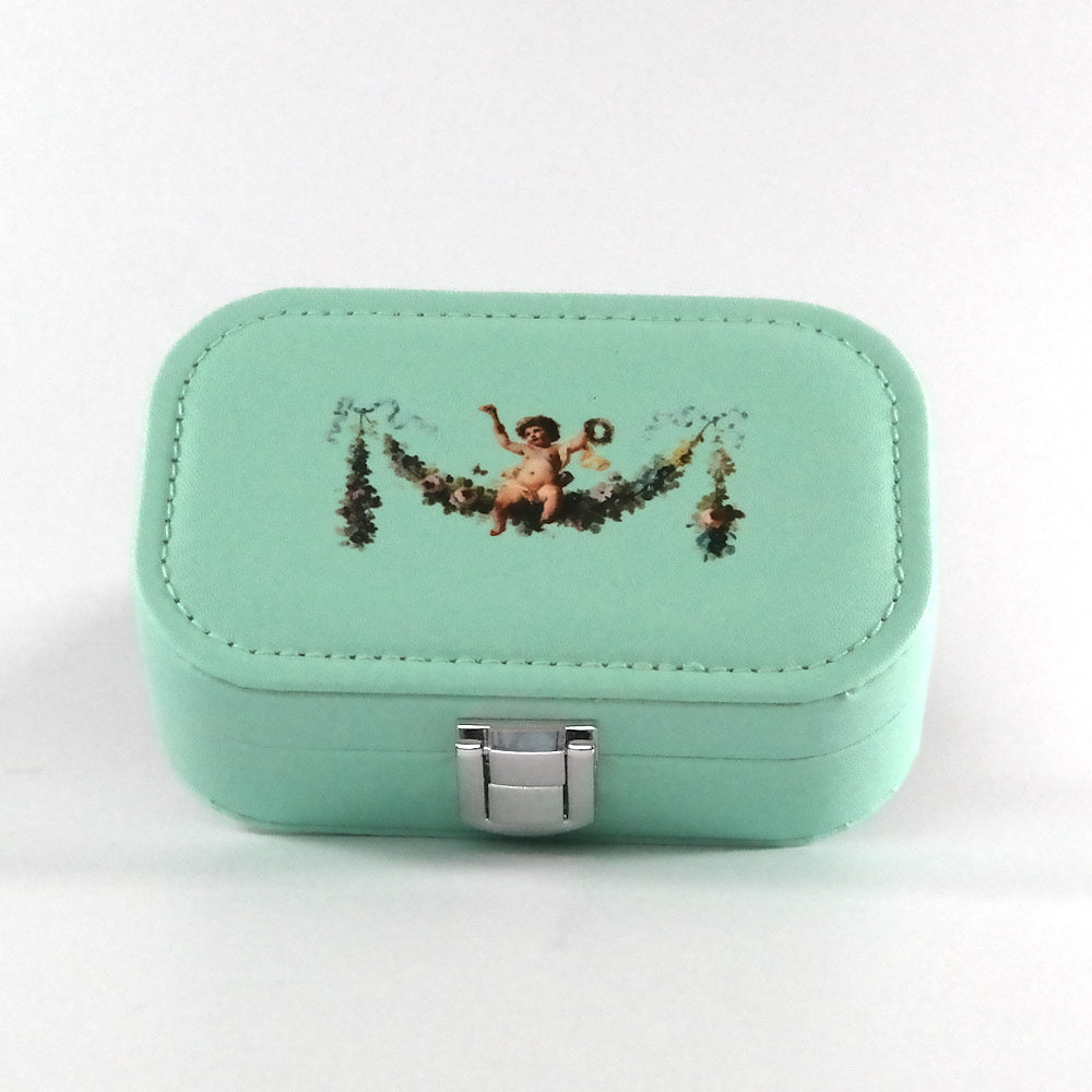 Mint green jewelry box with decorative design on a white background