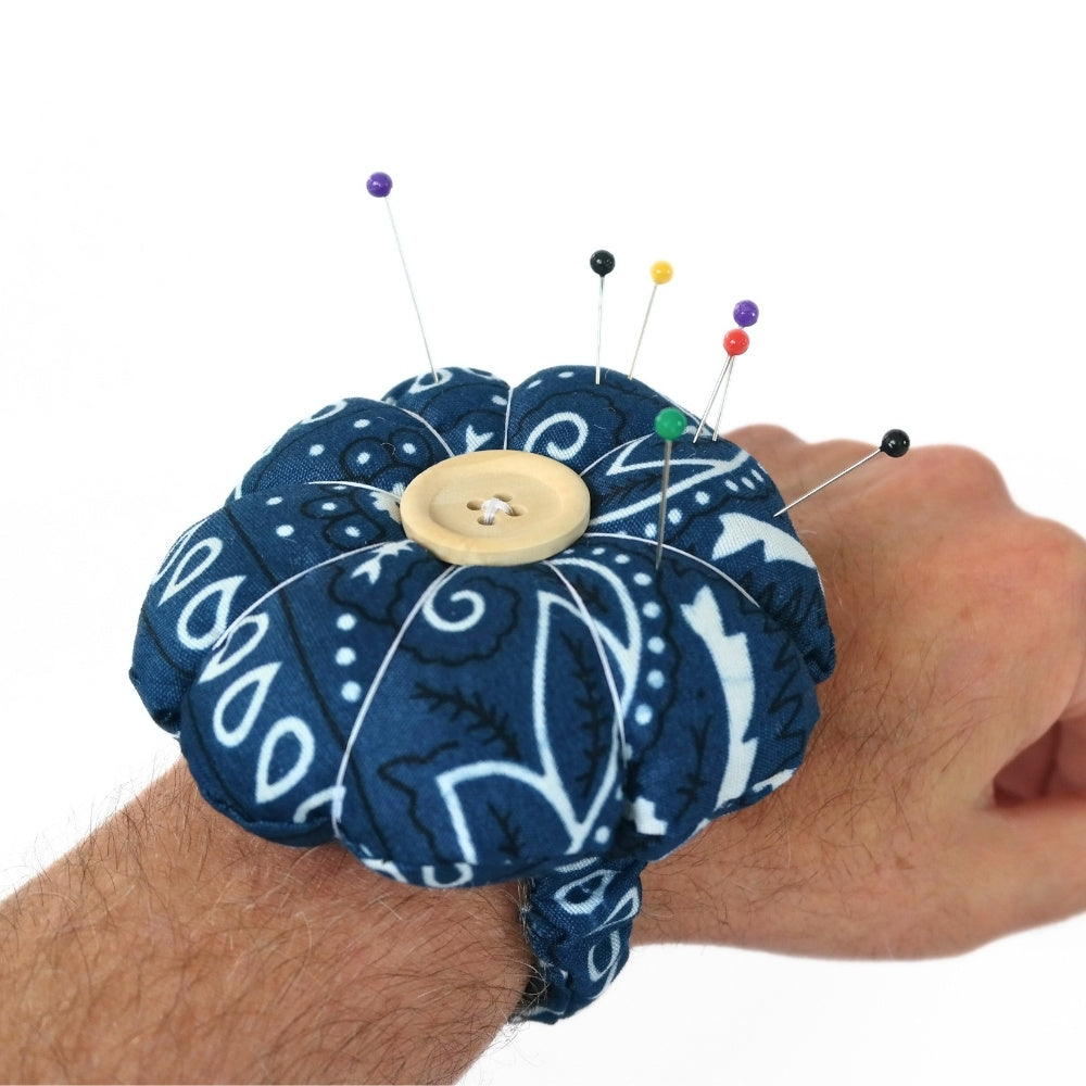 Finished Blue Flower Pin Cushion Wristband DIY kit worn on an arm. 