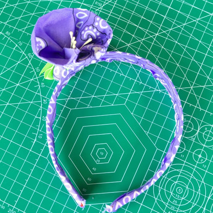 Bandana flower headband against a green crafting background. 