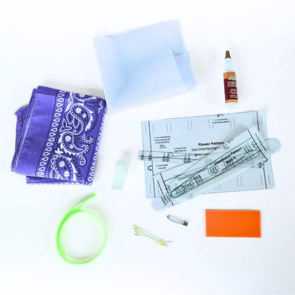 Crafting materials displayed on a white background: Bandana fabric, plastic headband frame, foam padding, fusible interfacing, ribbon, stamens, glue, glue dots, printed paper patterns