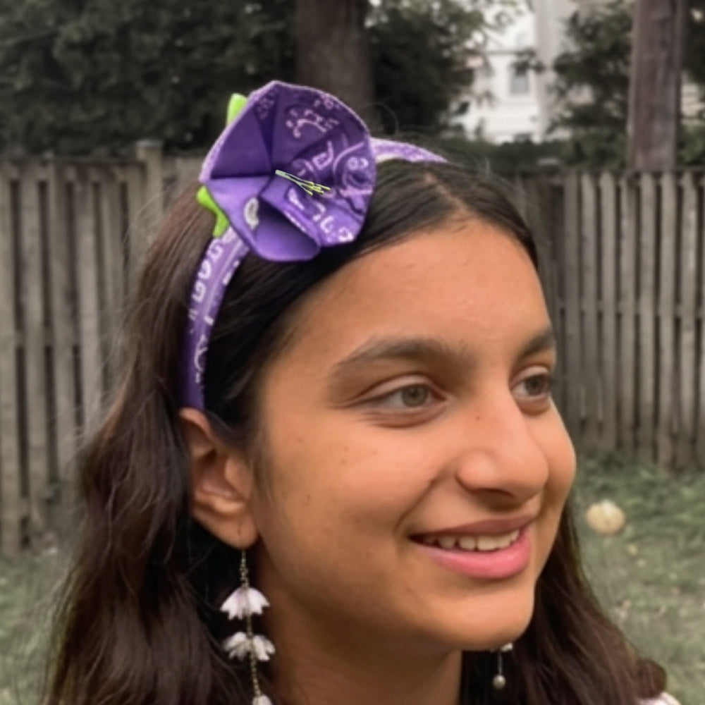 Portrait of a girl wearing the bandana flower headband from the side. 