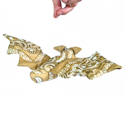 Back view of the finished Bandana Flying Bat suspended by its strings, showing the patterned fabric body and spread wings.
