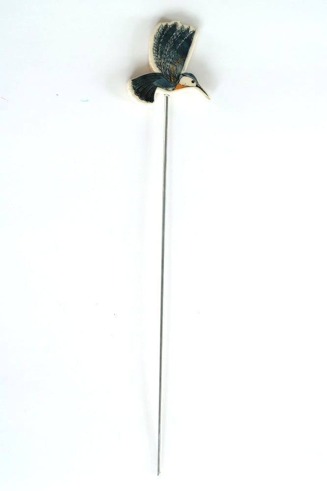 Decorative garden stake with a blue hummingbird design on a white background