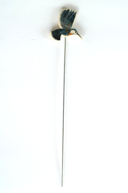 Decorative garden stake with a blue hummingbird design on a white background
