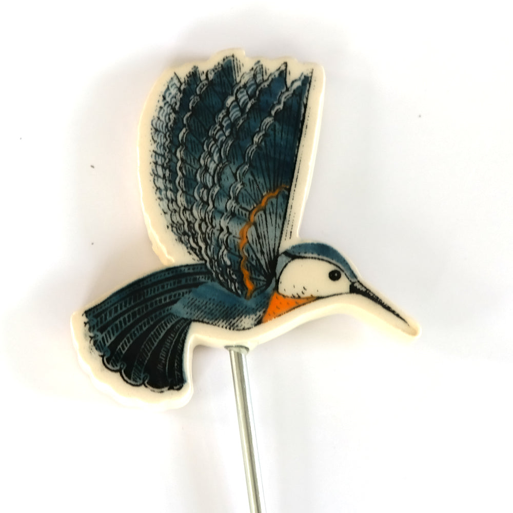 Decorative garden stake with a blue hummingbird design on a white background
