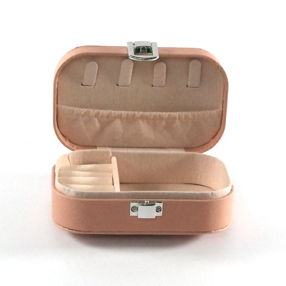 Miniature pink jewelry box open with compartments and a cream colored fabric.  