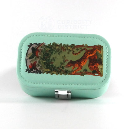 Mint green jewelry box with nature-themed design on a white background