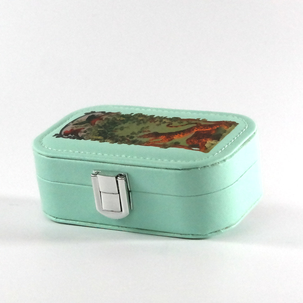 Miniature teal jewelry box with a button closure and a detail from Panthers of Bacchus Eating Grapes, pictured from the side. 
