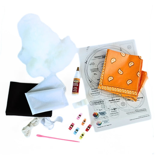 Bandana Pumpkin Trio DIY kit contents with orange bandana, stuffing, patterns, glue, felt, cord, clips, and tools