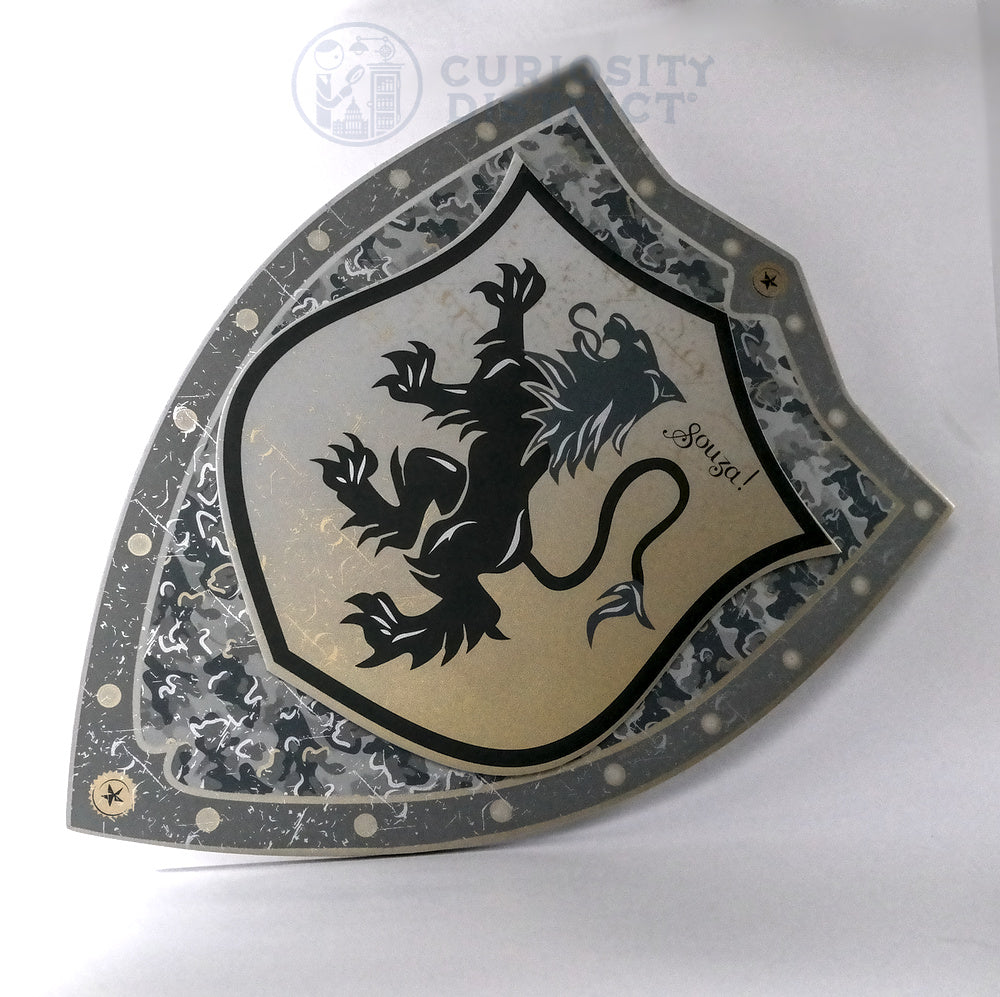 Decorative shield with a black lion emblem on a white background