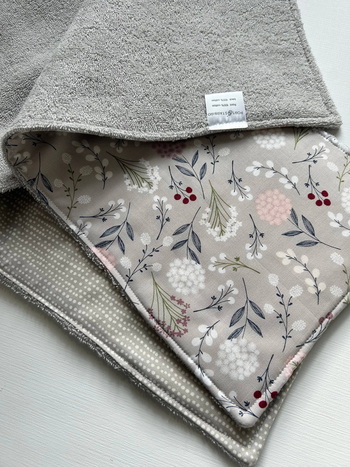 Image of the two Signature Burp Cloth with Grey Wildflowers design showing front and back. 