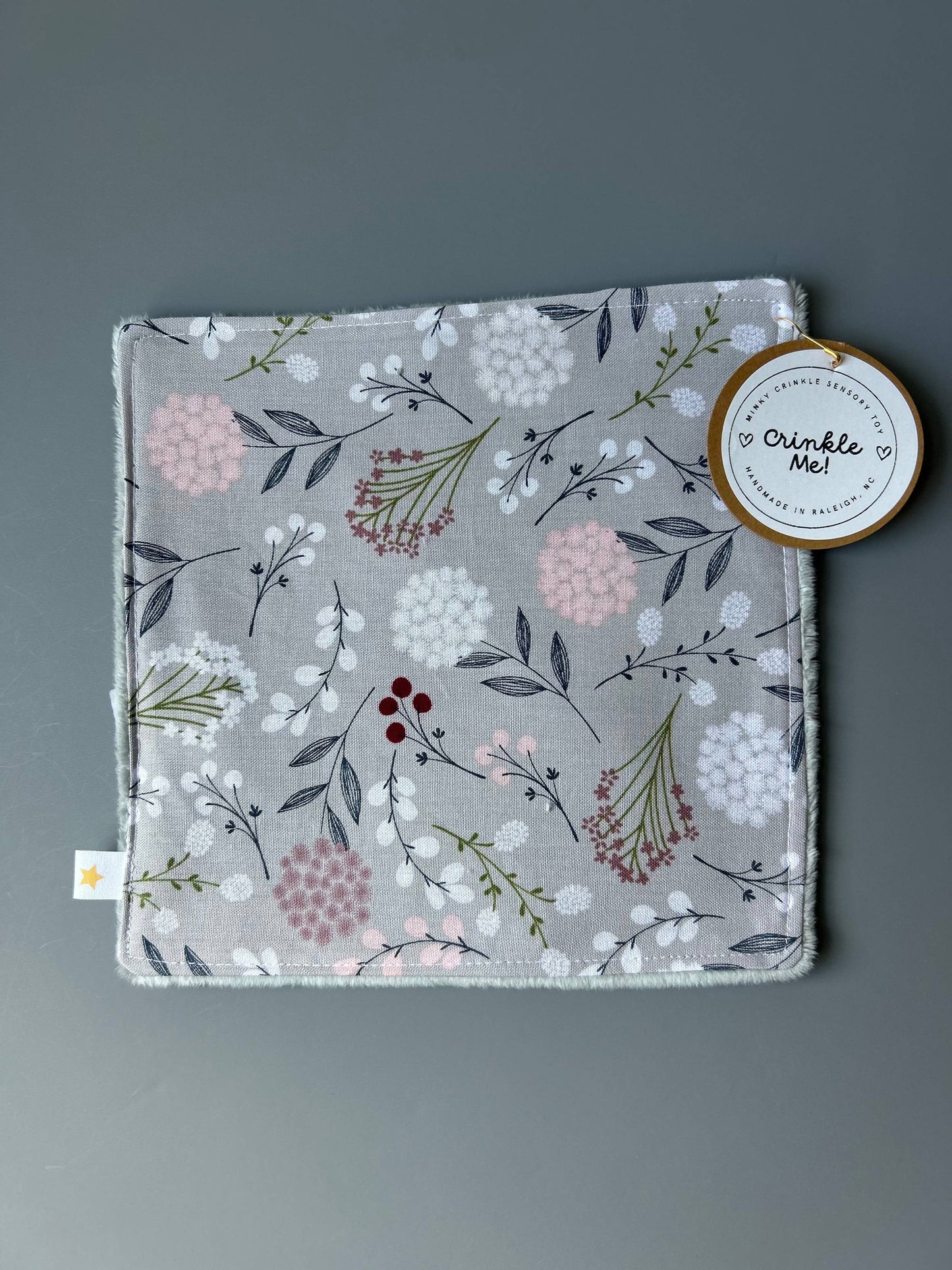Front view of the Signature Minky Crinkle Sensory Toy, Grey Wildflowers design