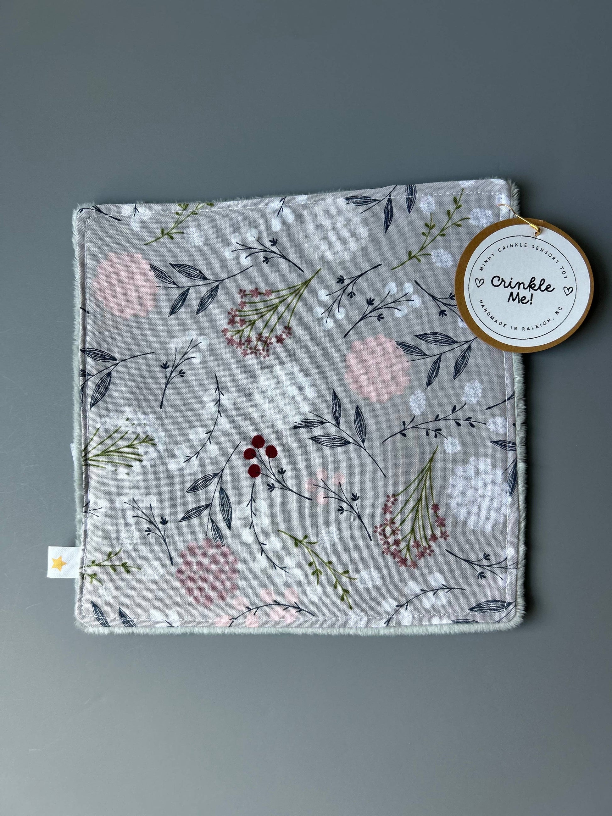 Front view of the Signature Minky Crinkle Sensory Toy, Grey Wildflowers design
