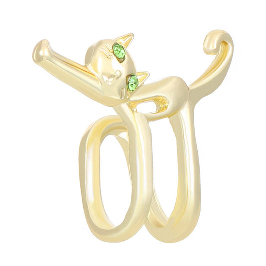 Gold cat-shaped ring with green eyes on a white background