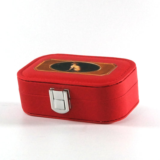 Miniature red jewelry box with a button closure and the portrait of a whippet, pictured from the side. 