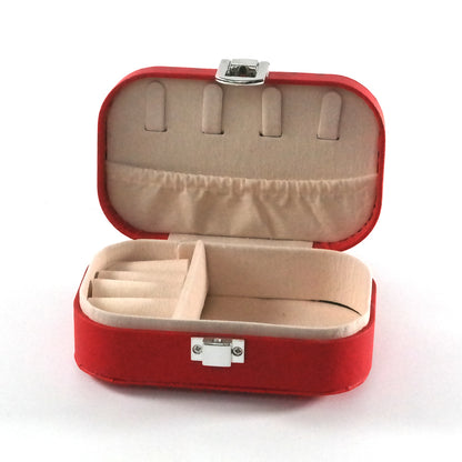 Miniature red jewelry box open with compartments and a cream colored fabric.  